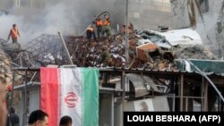 د اپرېل پر لومړۍ په دمشق کې کارکوونکي پر ایرانۍ قونسلګرۍ تر برید وروسته اور وژني.