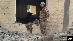 A Pakistani soldier examines the site of a suicide bombing in Dera Ismail Khan that killed nearly two dozen people on December 12.