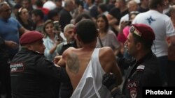 Armenia - Riot police detain a protester outside the Armenian Foreign Ministry building, May 31, 2024.