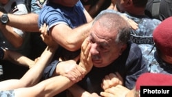 Armenia - Police officers use force against opposition lawmaker Aghvan Vartanian during an anti-government protest in Yerevan, May 30, 2022.