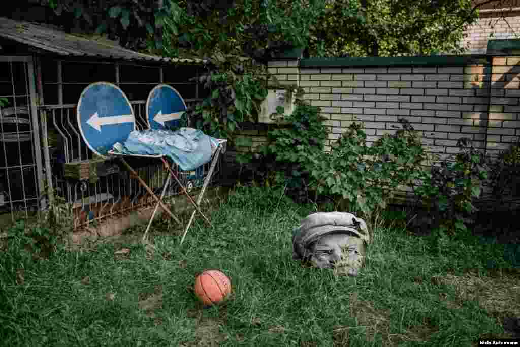 A Lenin head sits in the Kyiv garden of a volunteer who assisted the Ukrainian Army in fighting Russia-backed separatists. It was a birthday present from a group of soldiers she had helped. 