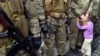Дитина біля свого батька – бійця добровольчого батальйону «Січ» у день присяги і відправлення підрозділу в зону бойових дій, Київ, 26 серпня 2014 року