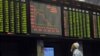 A Pakistani stockbroker watches share prices on a digital board during a trading session at the Pakistan Stock Exchange in Karachi (file photo)