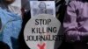 A Pakistani journalist holds a sign and a picture of Associated Press photographer Anja Niedringhaus,, who was killed on April 4, 2014, in Afghanistan, during a demonstration in Islamabad to condemn attacks against journalists.
