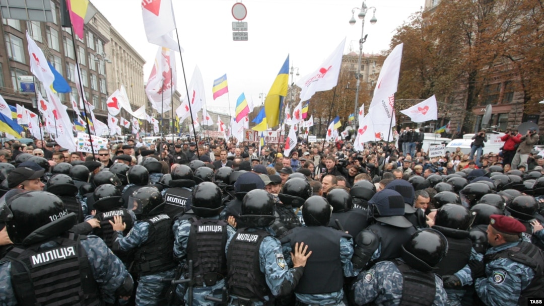 Riot police try to contain supporters of former Prime Minister Yulia Tymoshenko outside the district court in Kyiv that convicted her on October 11.