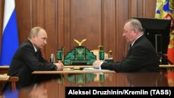 Russian President Vladimir Putin (left) and Transneft head Nikolai Tokarev meet at the Kremlin in Moscow on April 30. 