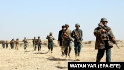 FILE: Afghan forces patrol in the southern province of Helmand in November.