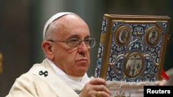 Vatican -- Pope Francis blesses the missal as he leads a mass on the 100th anniversary of the Armenian genocide, in St. Peter's Basilica at the Vatican, April 12, 2015