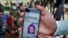 A local journalist shows a story published by an Italian news site regarding Sana Cheema, an Italian woman of Pakistani origin, in the neighborhood of Mangowal, near Gujrat.