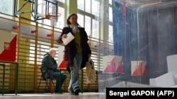 În imagine, alegătoare din Polonia, la o secție de vot din capitala Varșovia, duminică, 18 mai.