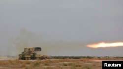 Iraq -- A Russian-made multiple rocket launcher known as the TOS-1A fires during training at a military camp in Baghdad October 14, 2014.