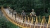 Indian border guards patrol on a footbridge built over a stream near the Line of Control (LoC), a cease-fire boundary that divides Kashmir between India and Pakistan. (file photo)
