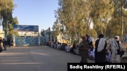 People wait in a long line to vote in parliamentary elections in Kandahar on October 27.