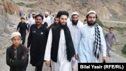 کېڼې خوا ته د تور واسکټ او تورې لونګۍ ولا تن مفتي سلطان محمد دی.