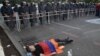 Armenia - A protester lies on the ground near riot police deployed on Marshal Bagramian Avenue, Yerevan, 26Jun2015.
