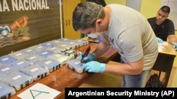 A police officer opens up a package of cocaine found in an annex building of the Russian Embassy in Buenos Aires in December 2016.