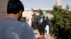 Afghans inspect the site of a suicide attack in Lashkar Gah, the capital of Helmand Province, on October 9.