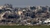 O fotografie realizată din sudul Israelului arată clădiri distruse în Fâșia Gaza, 17 ianuarie 2024.