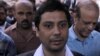 Pakistani journalist and Dawn newspaper assistant editor, Cyril Almeida, walks in to the district High Court ahead of a hearing on treason allegations, in Lahore on October 8.