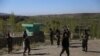Afghan security personnel keep watch at the site of an attack by Taliban militants on a government compound in the Khwaja Omari district in the southeastern province of Ghazni on April 12.