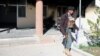 An Afghan policeman outside the government district building after a Taliban attack in the Khawaja Omari district of Ghazni Province on April 12.