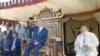 Президент Казахстана Нурсултан Назарбаев сидит на троне. Съемочная площадка фильма «Кочевники». 17 февраля 2004 года.