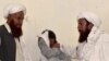 Men mourn the death of relatives and party workers, who were killed in a suicide bombing attack during an election campaign meeting near Quetta, the capital of southwestern Balochistan Province on July 13.